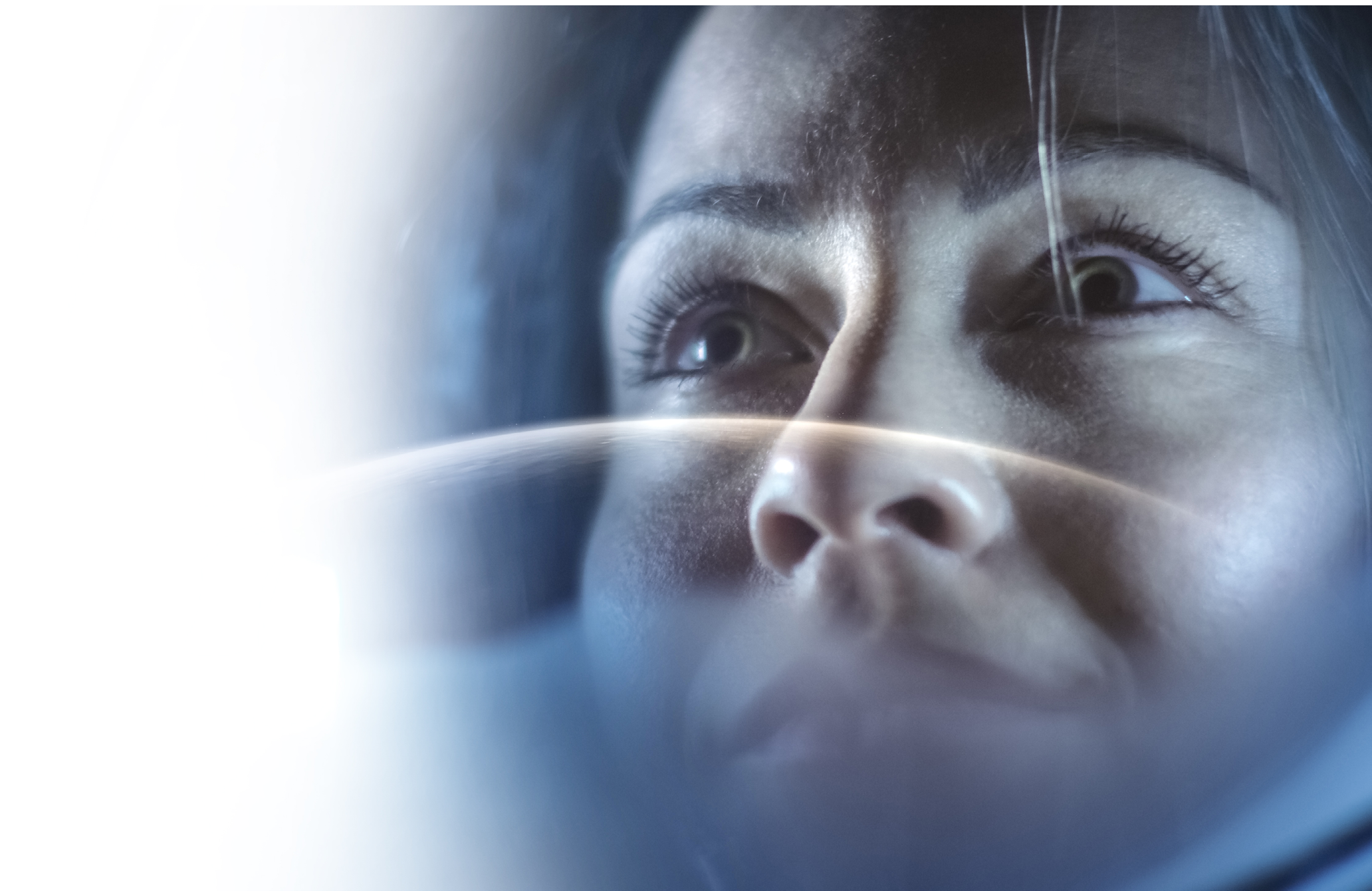 Portrait Shot of the Courageous Female Astronaut Wearing Helmet in Space, Looking around in Wonder. Space Travel, Exploration and Solar System Colonization Concept.